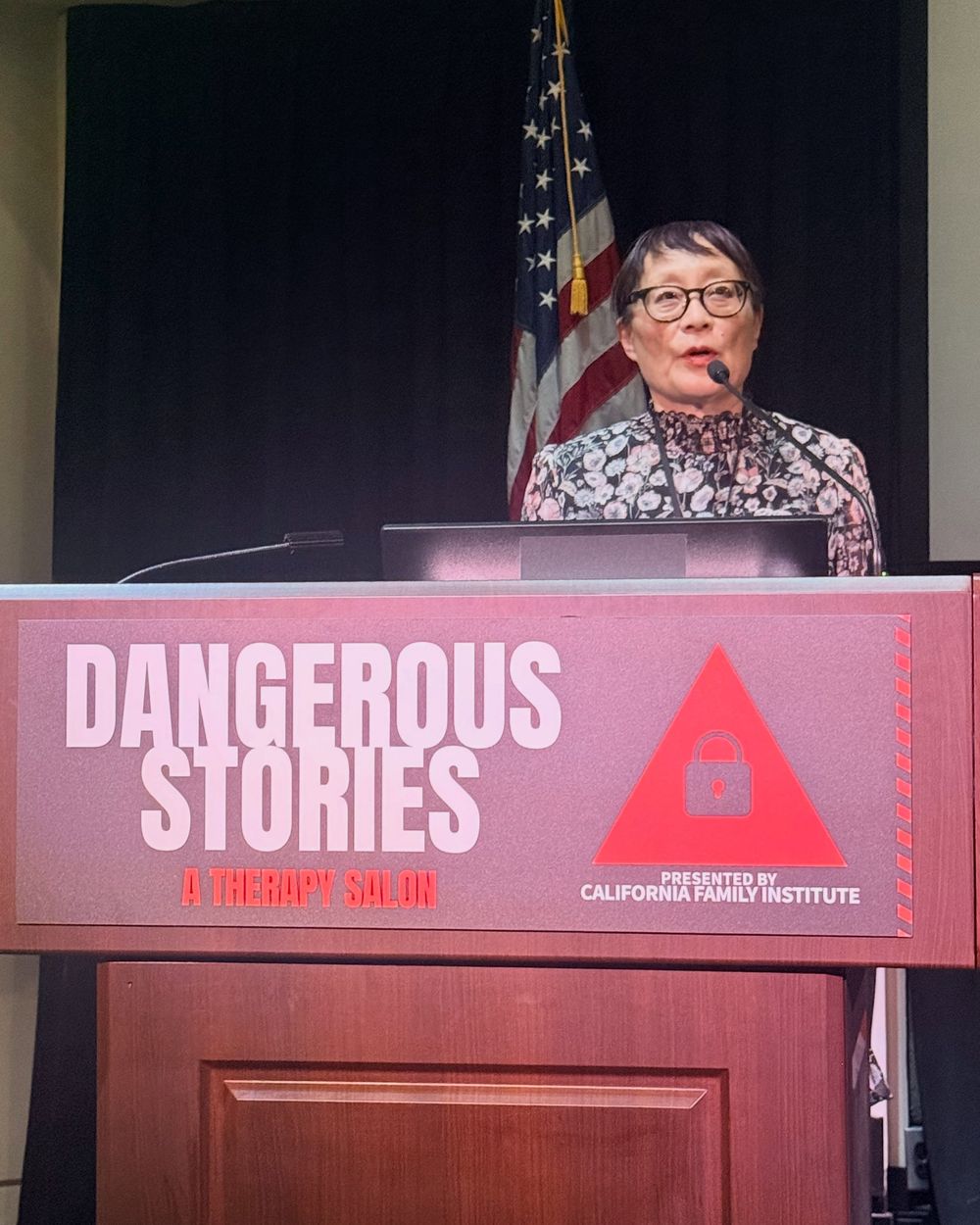 Catherine Liu speaking at the Dangerous Stories lectern