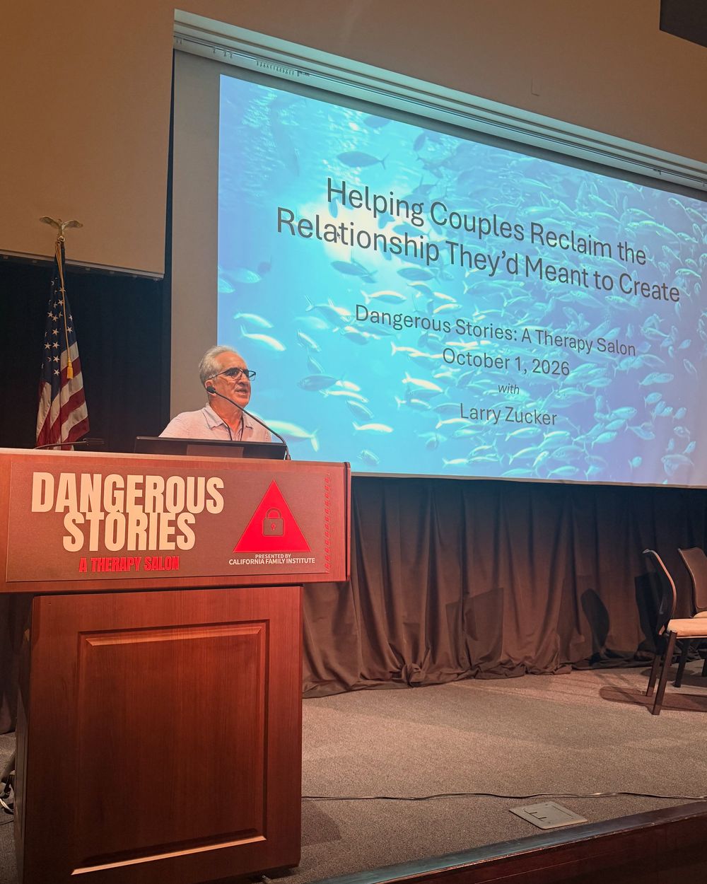 Larry Zucker at the lectern under his title slide